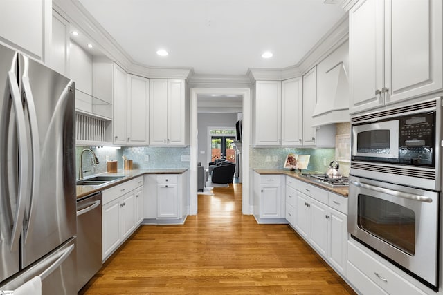 623 N Main St Unit Iii, Unit Iii, Greenville, SC 29601 - kitchen with stainless steel appliances, white cabinets, light wood-style floors, recessed lighting, and ornamental molding