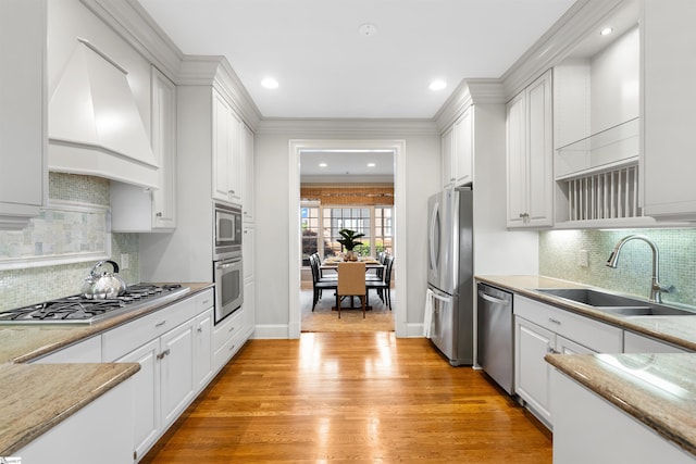623 N Main St Unit Iii, Unit Iii, Greenville, SC 29601 - kitchen with stainless steel appliances, premium range hood, white cabinetry, ornamental molding, and light wood-style floors