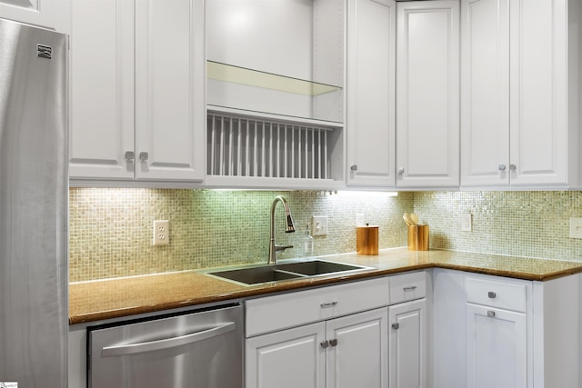 623 N Main St Unit Iii, Unit Iii, Greenville, SC 29601 - kitchen with appliances with stainless steel finishes, decorative backsplash, and white cabinetry