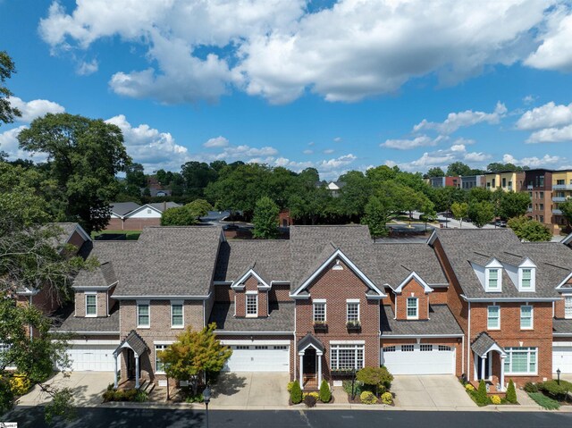 623 N Main St Unit Iii, Unit Iii, Greenville, SC 29601 - townhome / multi-family property featuring concrete driveway, a residential view, an attached garage, and brick siding