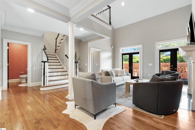 623 N Main St Unit Iii, Unit Iii, Greenville, SC 29601 - living area with french doors, ornate columns, stairway, light wood-style flooring, and ornamental molding