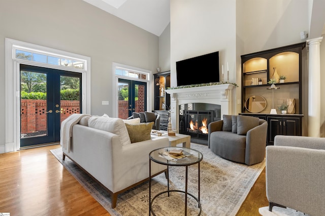 623 N Main St Unit Iii, Unit Iii, Greenville, SC 29601 - living room with french doors, high vaulted ceiling, a glass covered fireplace, and wood finished floors