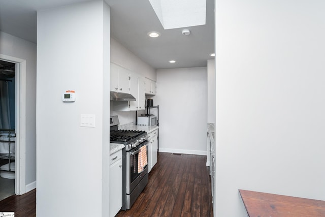 2701 Cobbs Way, Anderson, SC 29621 - kitchen with stainless steel gas range, under cabinet range hood, a skylight, dark wood-style flooring, and white cabinets