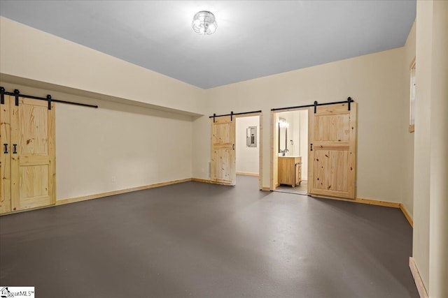 1150 Chinquapin Rd, Travelers Rest, SC 29690 - unfurnished room with a barn door, finished concrete flooring, and electric panel