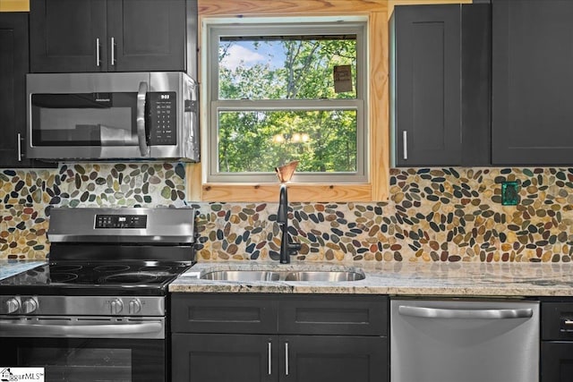 1150 Chinquapin Rd, Travelers Rest, SC 29690 - kitchen featuring appliances with stainless steel finishes, backsplash, and light stone countertops