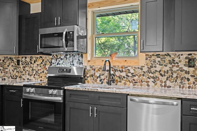 1150 Chinquapin Rd, Travelers Rest, SC 29690 - kitchen with appliances with stainless steel finishes, backsplash, and light stone countertops