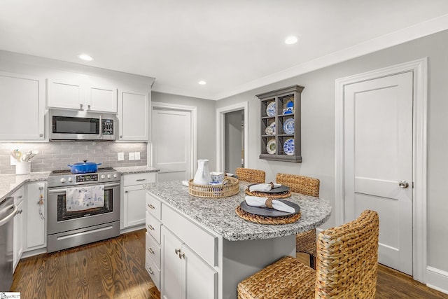 2109 Hudson Rd, Greer, SC 29650 - kitchen with stainless steel appliances, dark wood-style flooring, white cabinets, light stone counters, and recessed lighting