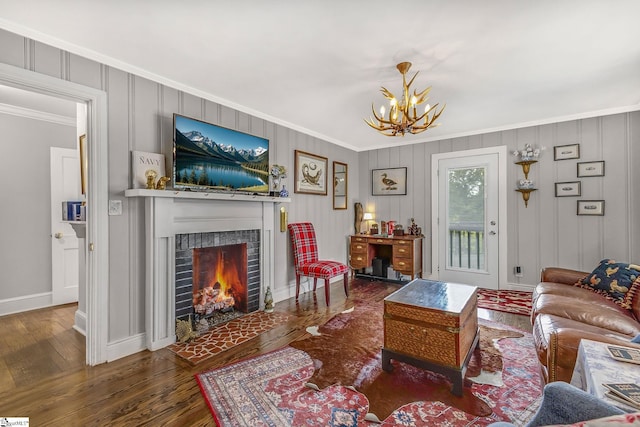 2109 Hudson Rd, Greer, SC 29650 - living area with crown molding, a chandelier, wood finished floors, and a fireplace with flush hearth