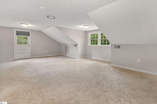 2109 Hudson Rd, Greer, SC 29650 - bonus room with vaulted ceiling, light colored carpet, healthy amount of natural light, and a textured ceiling