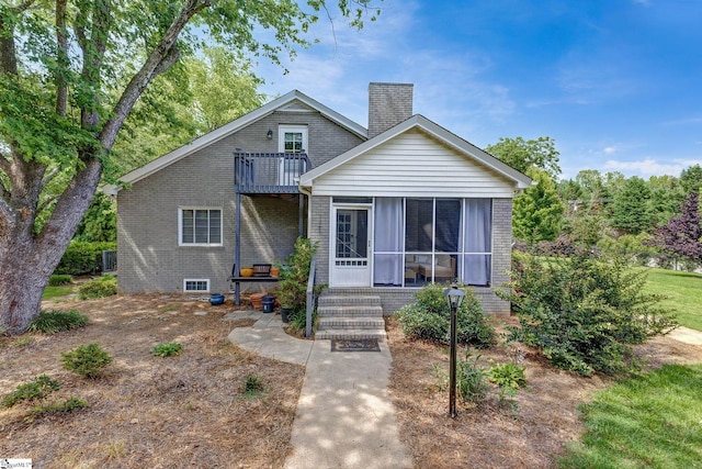 2109 Hudson Rd, Greer, SC 29650 - bungalow featuring a balcony, a chimney, brick siding, and a sunroom
