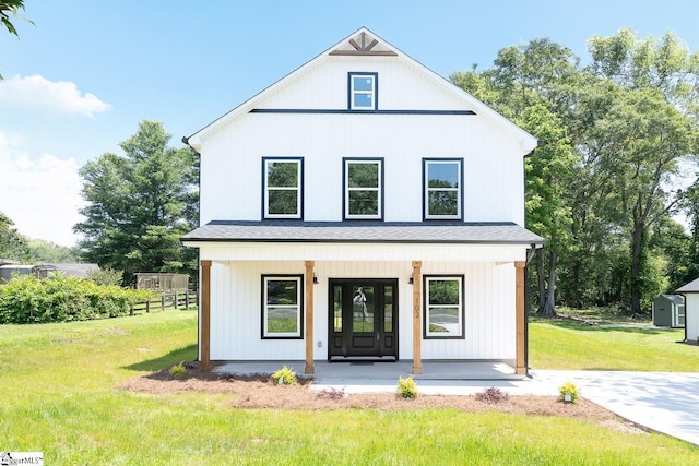 103 Cedar Falls Rd, Fountain Inn, SC 29644 - modern farmhouse featuring covered porch, a front yard, and a shingled roof