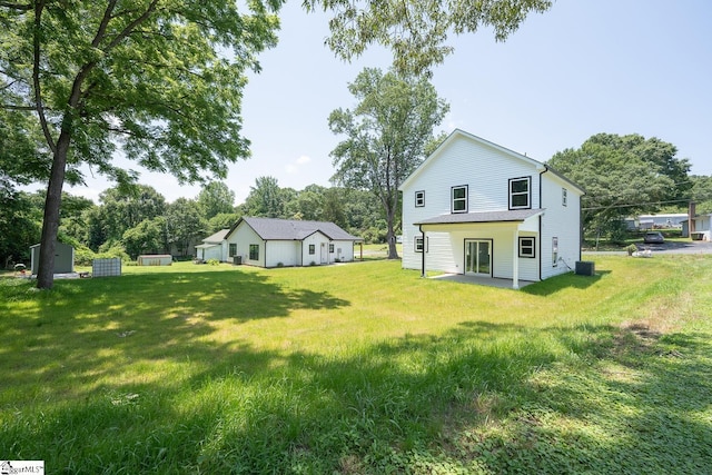 103 Cedar Falls Rd, Fountain Inn, SC 29644 - back of house with a lawn, view of wooded area, and an outbuilding
