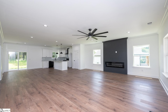 103 Cedar Falls Rd, Fountain Inn, SC 29644 - unfurnished living room with ornamental molding, a ceiling fan, a large fireplace, recessed lighting, and dark wood-type flooring