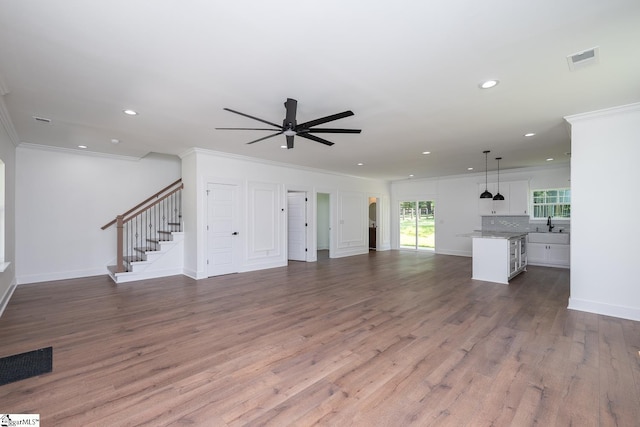103 Cedar Falls Rd, Fountain Inn, SC 29644 - unfurnished living room with ornamental molding, a ceiling fan, recessed lighting, stairs, and wood finished floors