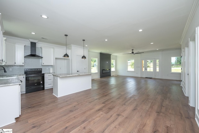 103 Cedar Falls Rd, Fountain Inn, SC 29644 - kitchen featuring black electric range oven, wall chimney exhaust hood, ceiling fan, crown molding, and open floor plan