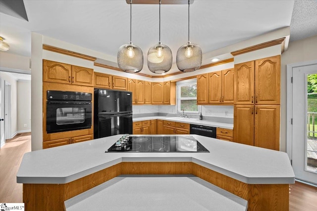 121 Chesterfield Ct, Easley, SC 29640 - kitchen featuring black appliances, light countertops, wood finished floors, and hanging light fixtures