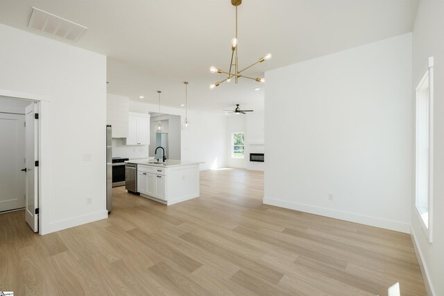 200 Folk Rd, Chesnee, SC 29323 - kitchen featuring open floor plan, light wood-style flooring, a chandelier, light countertops, and white cabinets