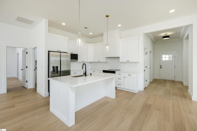 200 Folk Rd, Chesnee, SC 29323 - kitchen with stainless steel refrigerator with ice dispenser, light wood-type flooring, backsplash, light countertops, and white cabinets