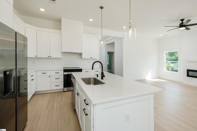 200 Folk Rd, Chesnee, SC 29323 - kitchen with appliances with stainless steel finishes, light wood-type flooring, decorative backsplash, open floor plan, and ceiling fan