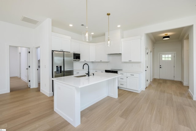 196 Folk Rd, Chesnee, SC 29323 - kitchen with stainless steel appliances, backsplash, light wood-type flooring, light countertops, and decorative light fixtures
