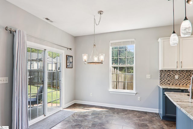 236 Worcester Ln, Easley, SC 29642 - unfurnished dining area featuring plenty of natural light, a chandelier, and dark stone finish flooring