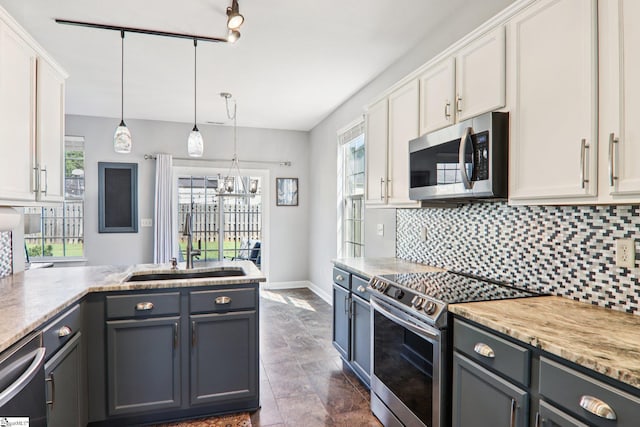 236 Worcester Ln, Easley, SC 29642 - kitchen with appliances with stainless steel finishes, decorative backsplash, white cabinetry, and pendant lighting