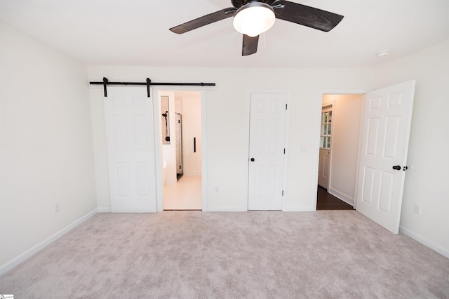 232 Silverbell Dr, Boiling Springs, SC 29316 - unfurnished bedroom featuring carpet, a barn door, and a ceiling fan