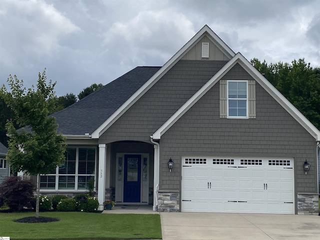 113 River Pines Trl, Greer, SC 29651 - view of front facade featuring a front lawn, stone siding, concrete driveway, and a garage