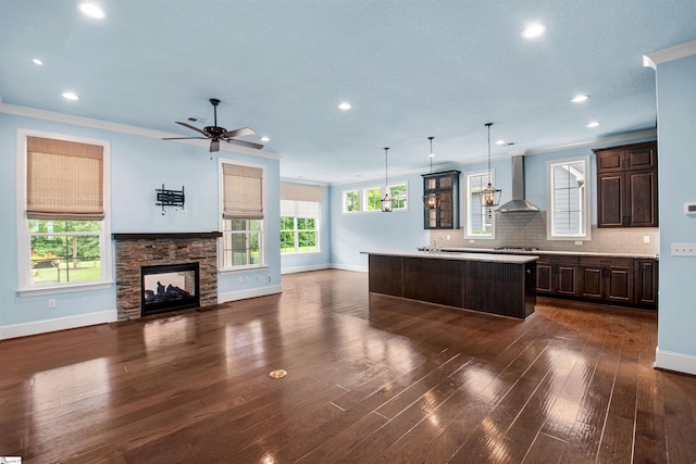 113 River Pines Trl, Greer, SC 29651 - kitchen featuring wall chimney exhaust hood, dark brown cabinetry, open floor plan, recessed lighting, and light countertops