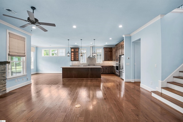 113 River Pines Trl, Greer, SC 29651 - kitchen featuring crown molding, open floor plan, light countertops, dark brown cabinets, and a center island with sink