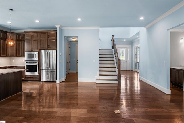 113 River Pines Trl, Greer, SC 29651 - kitchen featuring stainless steel appliances, dark brown cabinets, crown molding, dark wood-style floors, and backsplash