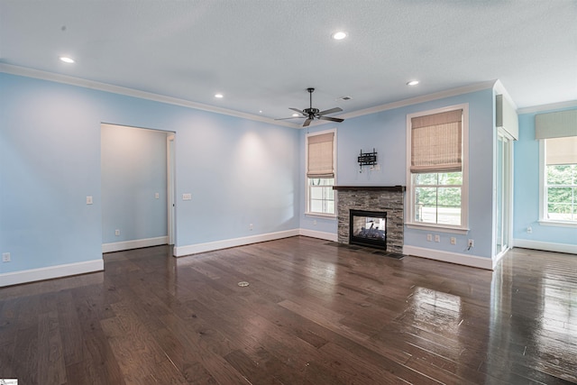 113 River Pines Trl, Greer, SC 29651 - unfurnished living room with crown molding, ceiling fan, dark wood-type flooring, a stone fireplace, and recessed lighting