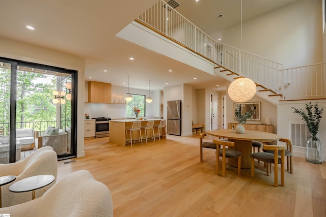 454 Enoree Rd, Travelers Rest, SC 29690 - dining room featuring light wood-style floors, stairs, recessed lighting, and a high ceiling
