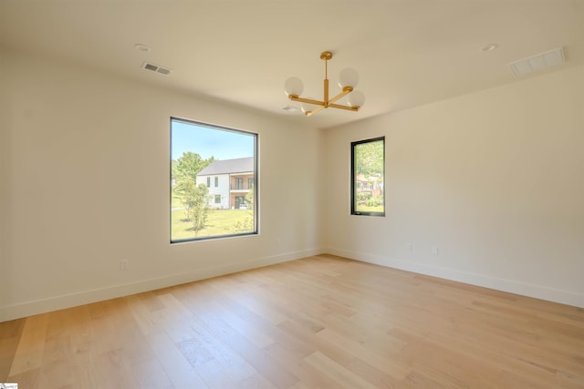 454 Enoree Rd, Travelers Rest, SC 29690 - empty room featuring a chandelier and light wood-style flooring