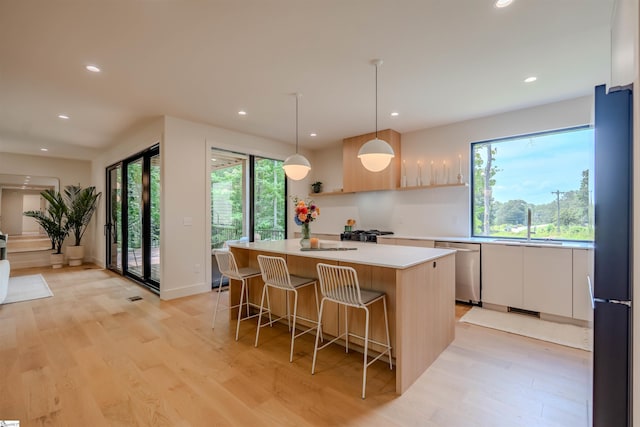 454 Enoree Rd, Travelers Rest, SC 29690 - kitchen featuring dishwasher, a center island, freestanding refrigerator, recessed lighting, and light countertops
