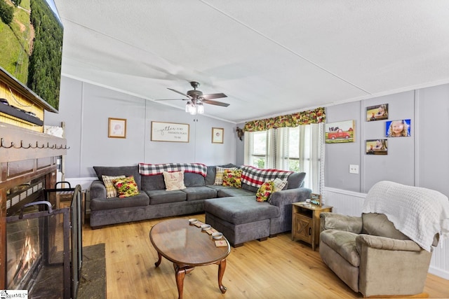 419-425 Chesapeake Trl, Pickens, SC 29671 - living area featuring crown molding, a lit fireplace, light wood-style floors, ceiling fan, and a decorative wall