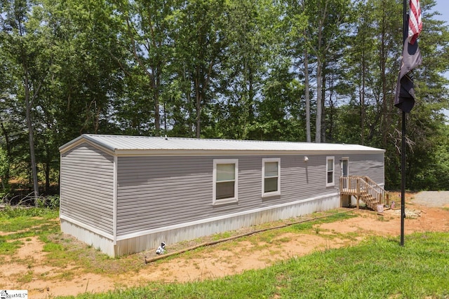 419-425 Chesapeake Trl, Pickens, SC 29671 - view of property exterior with a metal roof and view of wooded area
