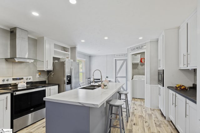 419-425 Chesapeake Trl, Pickens, SC 29671 - kitchen featuring stainless steel appliances, wall chimney range hood, washer / dryer, open shelves, and light wood finished floors