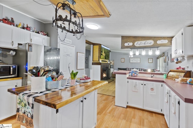 419-425 Chesapeake Trl, Pickens, SC 29671 - kitchen with stainless steel microwave, light wood-style floors, fridge, and white cabinets