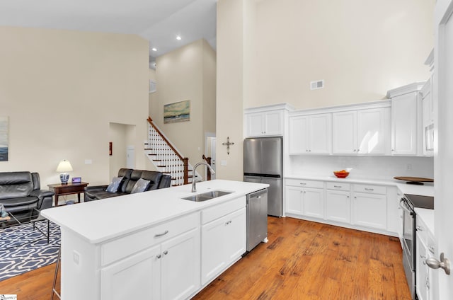 104 Mares Head Pl, Taylors, SC 29687 - kitchen with high vaulted ceiling, appliances with stainless steel finishes, open floor plan, light countertops, and white cabinetry