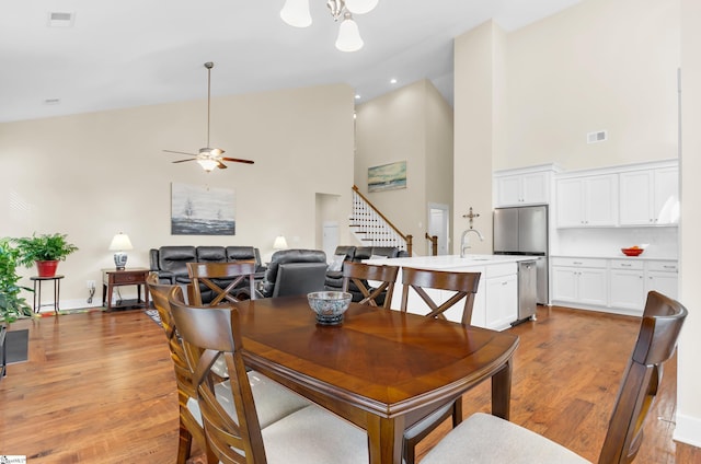 104 Mares Head Pl, Taylors, SC 29687 - dining room with high vaulted ceiling, light wood-type flooring, a ceiling fan, and stairs