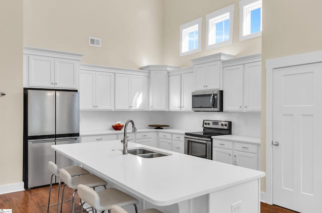 104 Mares Head Pl, Taylors, SC 29687 - kitchen featuring stainless steel appliances, a towering ceiling, white cabinetry, tasteful backsplash, and a breakfast bar