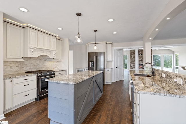 600 Packs Mountain Ridge Rd, Taylors, SC 29687 - kitchen with high quality appliances, decorative columns, a kitchen island, custom range hood, and dark wood-style flooring