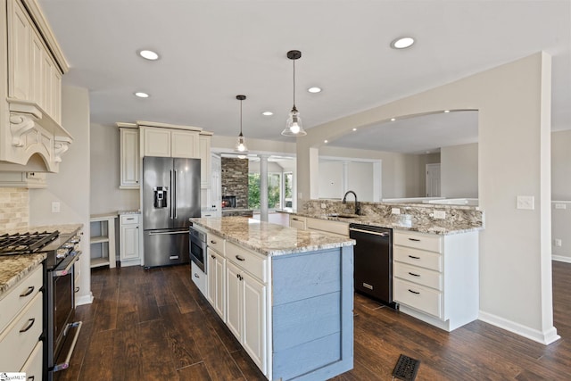 600 Packs Mountain Ridge Rd, Taylors, SC 29687 - kitchen featuring premium appliances, dark wood finished floors, decorative backsplash, recessed lighting, and a kitchen island
