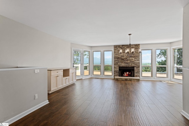 600 Packs Mountain Ridge Rd, Taylors, SC 29687 - unfurnished living room featuring dark wood finished floors, a chandelier, and a fireplace