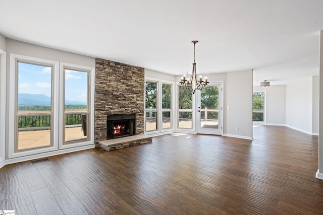 600 Packs Mountain Ridge Rd, Taylors, SC 29687 - unfurnished living room featuring dark wood-style flooring, a chandelier, and a fireplace