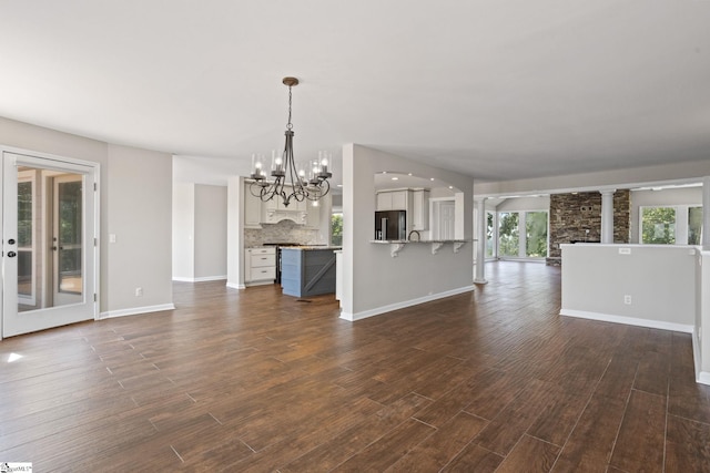600 Packs Mountain Ridge Rd, Taylors, SC 29687 - unfurnished living room with dark wood finished floors and a chandelier