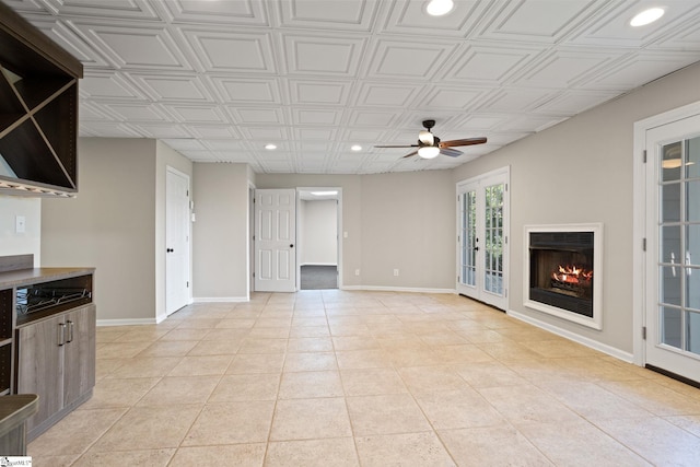 600 Packs Mountain Ridge Rd, Taylors, SC 29687 - unfurnished living room with recessed lighting, a ceiling fan, a lit fireplace, and light tile patterned floors