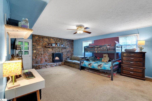 5 Nova St, Taylors, SC 29687 - carpeted bedroom featuring a stone fireplace, a ceiling fan, and a textured ceiling
