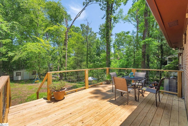 5 Nova St, Taylors, SC 29687 - deck with outdoor dining area and a shed